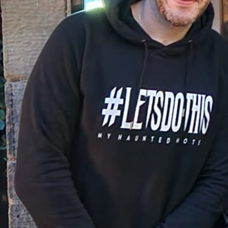 a man in a black hoodie displaying #LETSDOTHIS